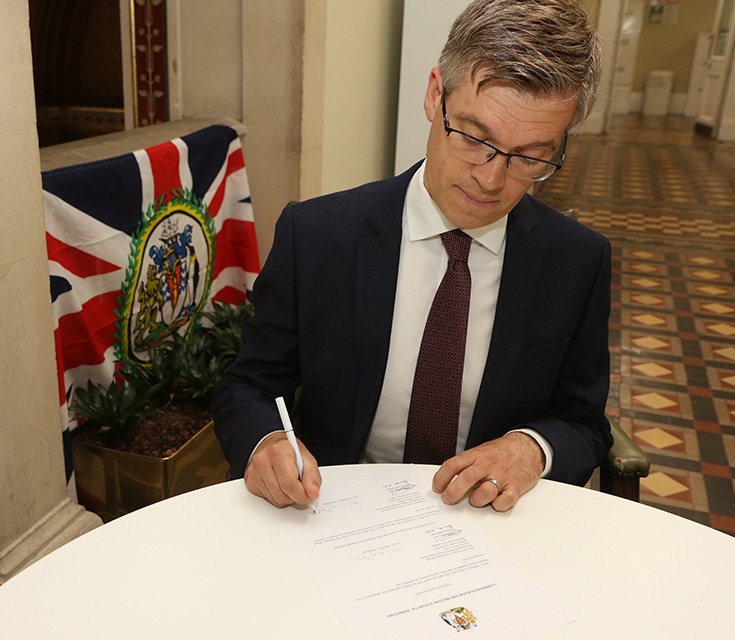 BAT Commissioner Paul Candler with the Flag of the Commissioner of the British Antarctic Territory